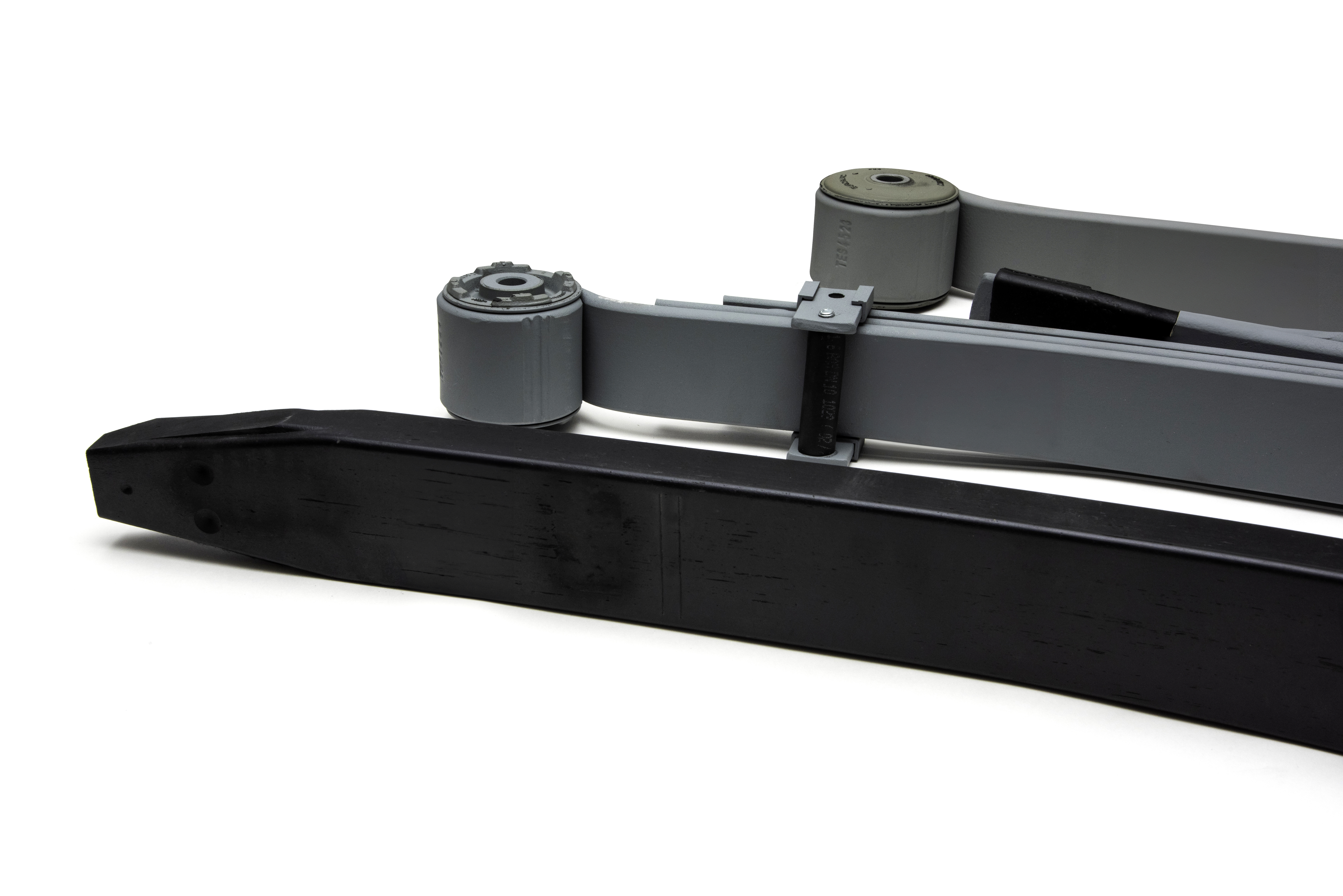 Close-up of three leaf springs in grey and black aligned side by side on a white background.