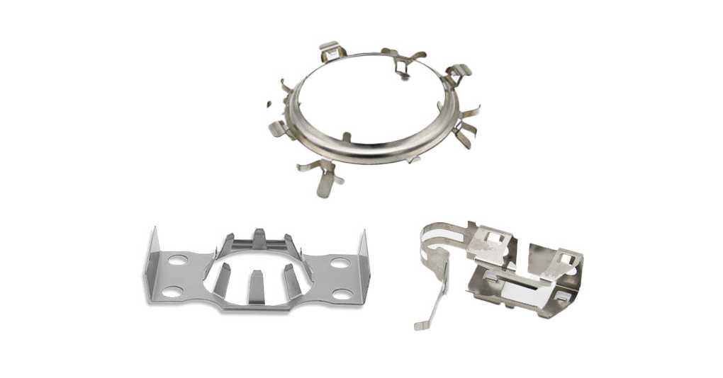 Three metallic stamped clips in different shapes and sizes, each with multiple prongs.