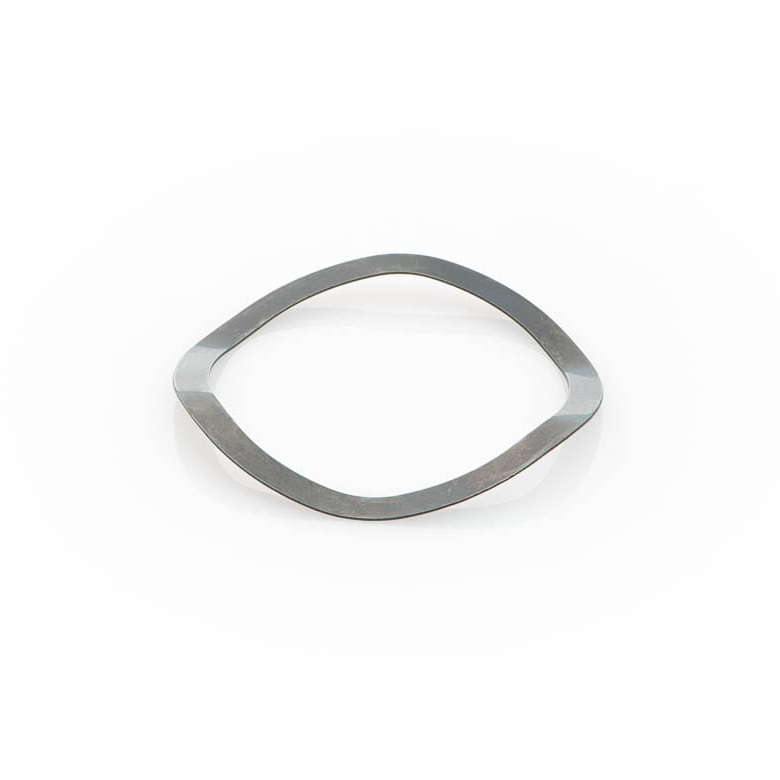 A thin, flat metal wave washer with a slightly irregular, wave-like shape on a transparent background.